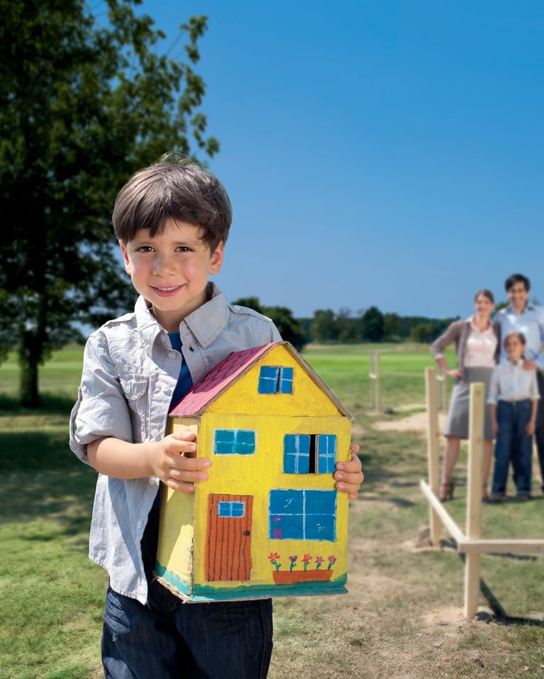 Boy_holding_house_model-boy.jpg
