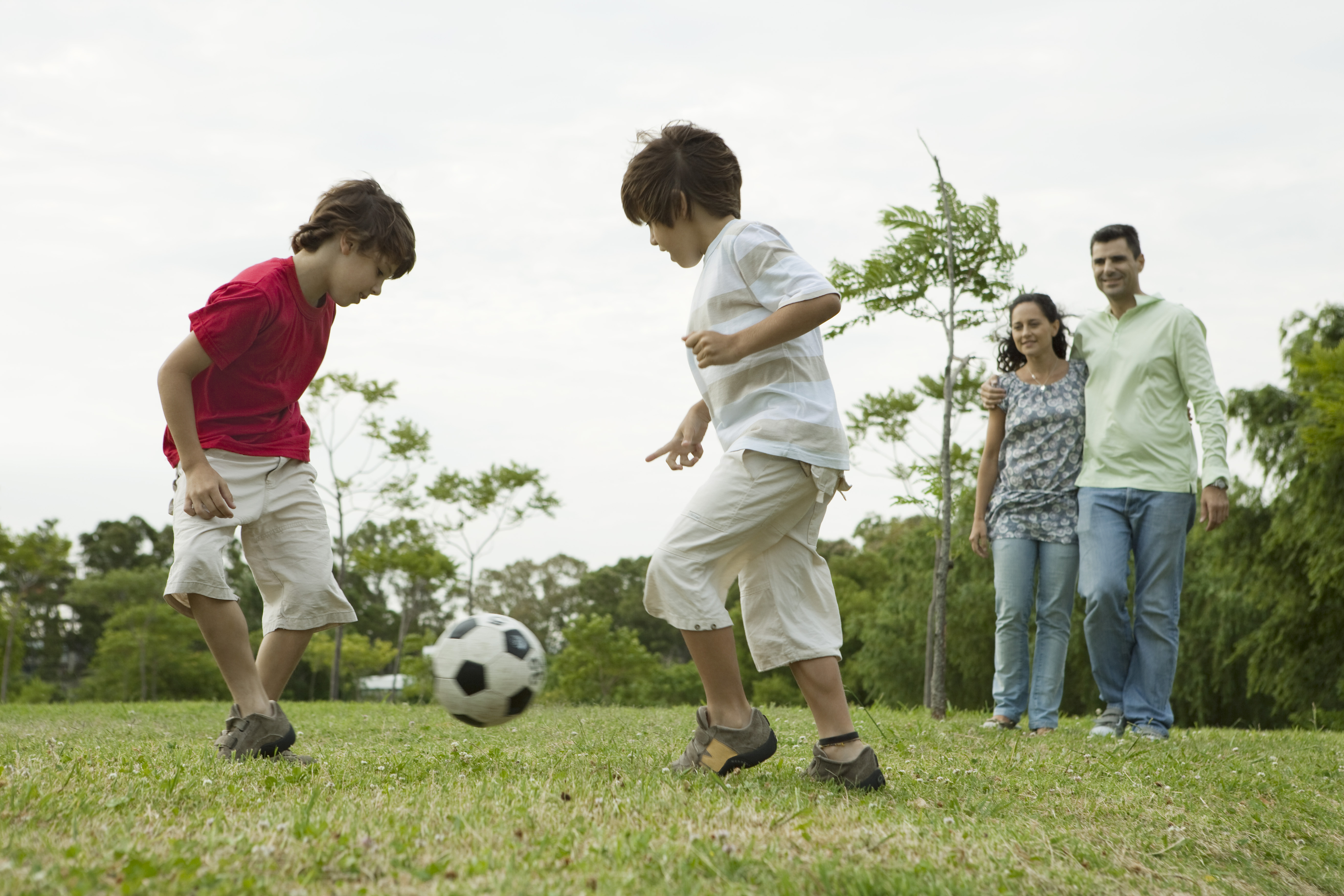 boys_playing_soccer_with_paren.jpg