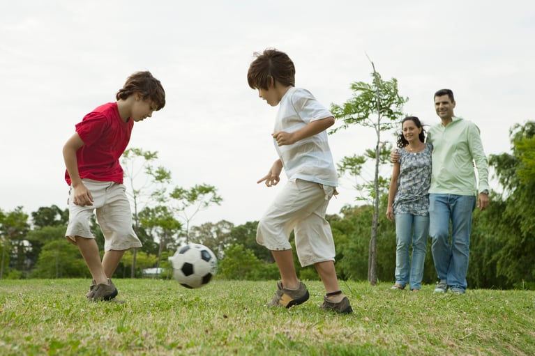 boys_playing_soccer_with_paren.jpg