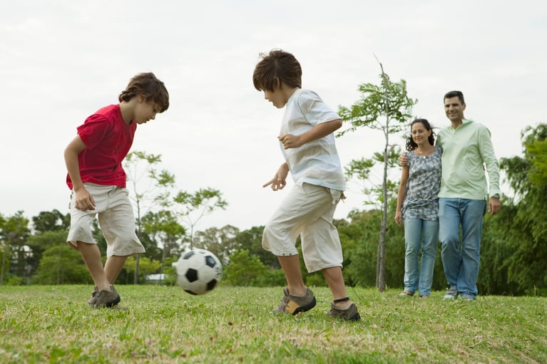 boys_playing_soccer_with_paren.jpg
