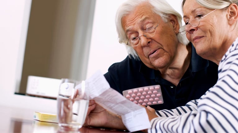 Senior couple reading package insert