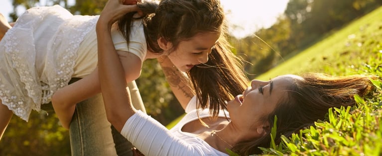Mother_and_daughter_playing_on_the_grass-2.jpg