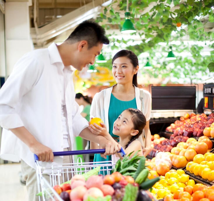 Family shopping groceries in supermarket