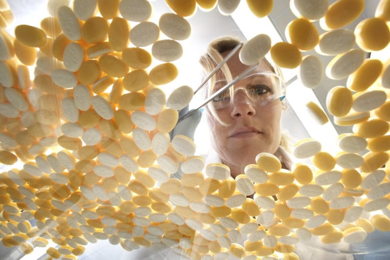 Researcher with Aspirin Tablet