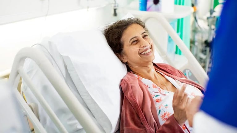 smiling-patient-in-hospital-bed.jpg