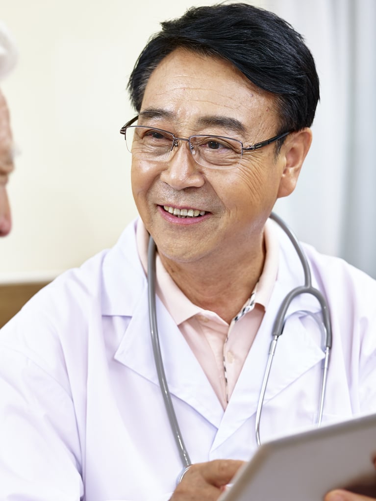 asian_doctor_talking_to_a_smiling_patient.jpg