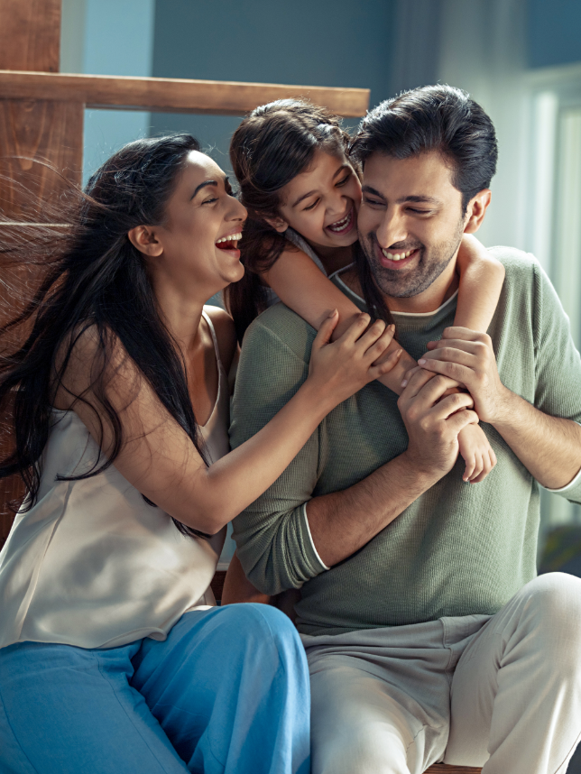 A mother, father and their daughter in joy