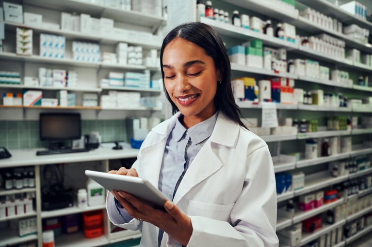 smiling pharmacist with tablet pc