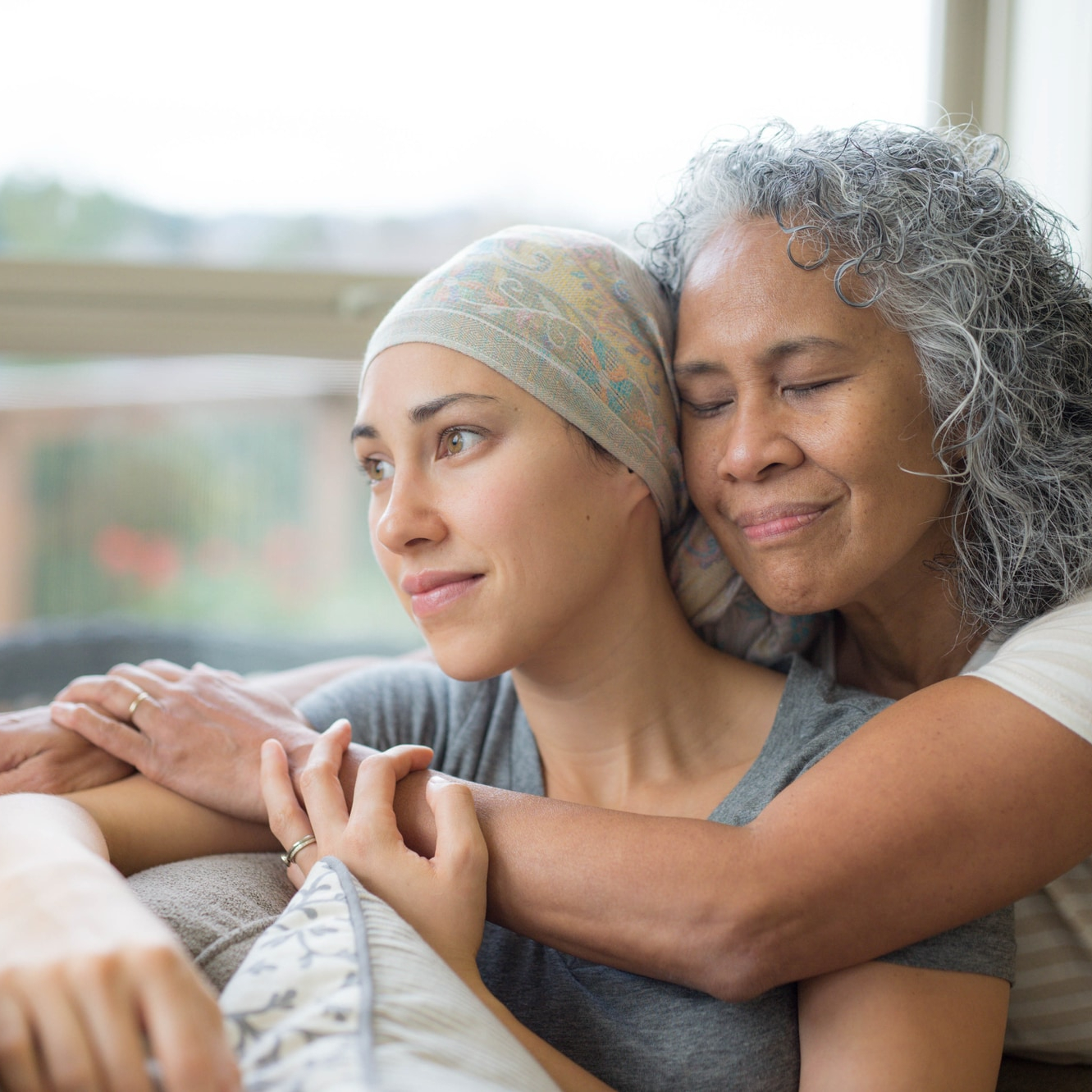 Senior woman hugging her daughter