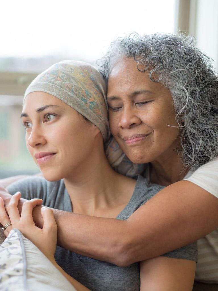 Senior woman hugging her daughter