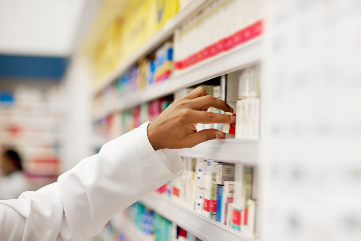 Image of Pharmacist taking medicine from rack