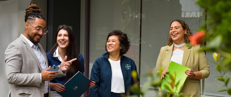 quatre collègues discutent à l'extérieur