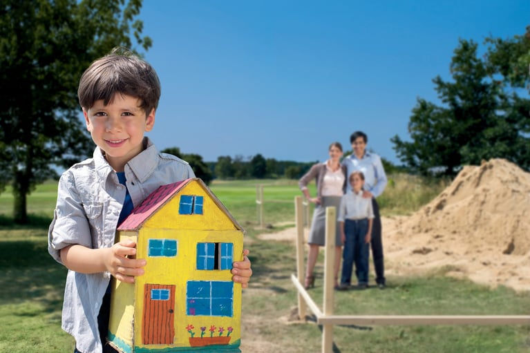 Boy_holding_house_model.jpg