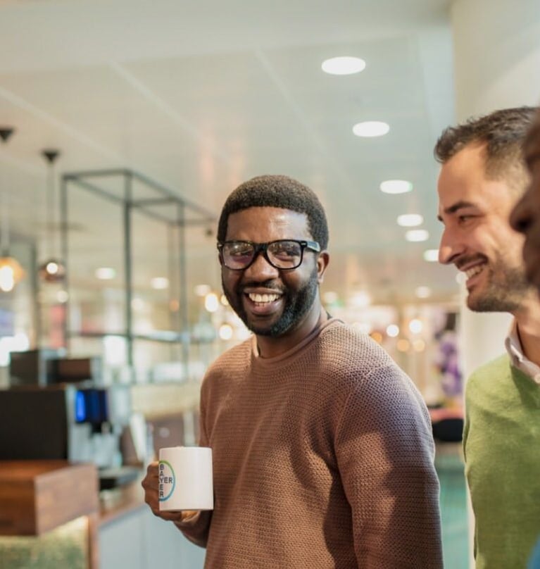 Employee at Bayer holding a mug