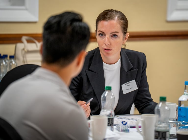 Woman discussing with man over a table
