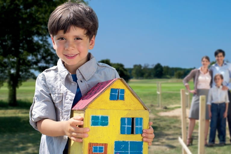 Boy_holding_house_model-boy.jpg