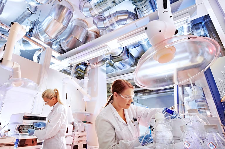 Kaksi henkilöä työskentelee laboratoriossa.