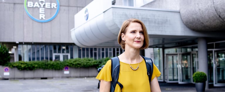 employee_in_front_of_bayer_building (1).jpg