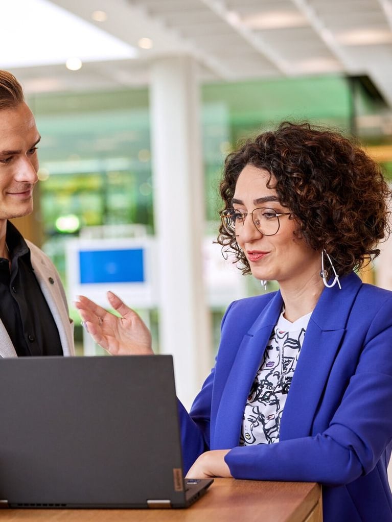 bayer employees in front of a laptop