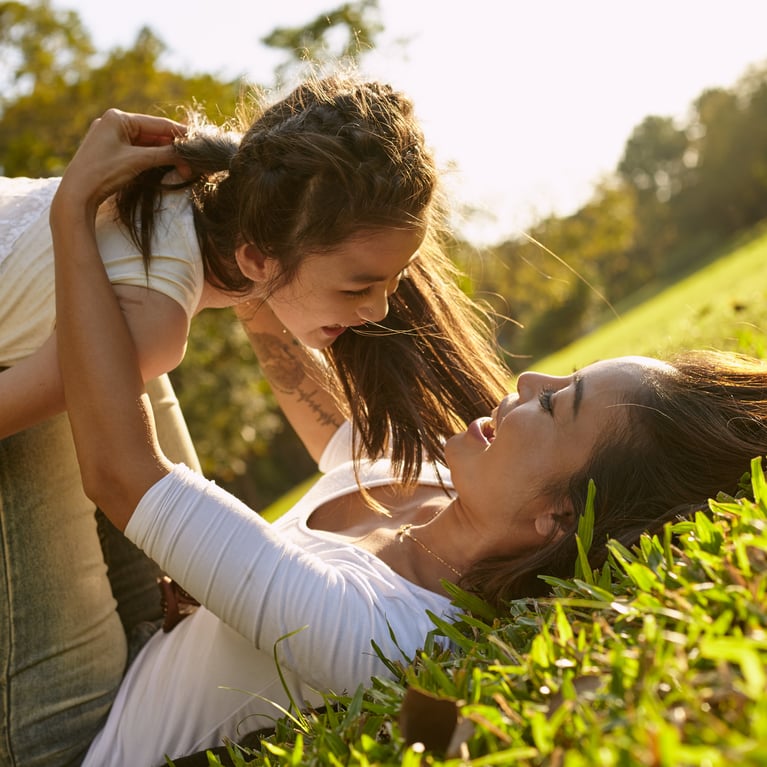 mother_and_daughter_playing_on_the_grass.jpg