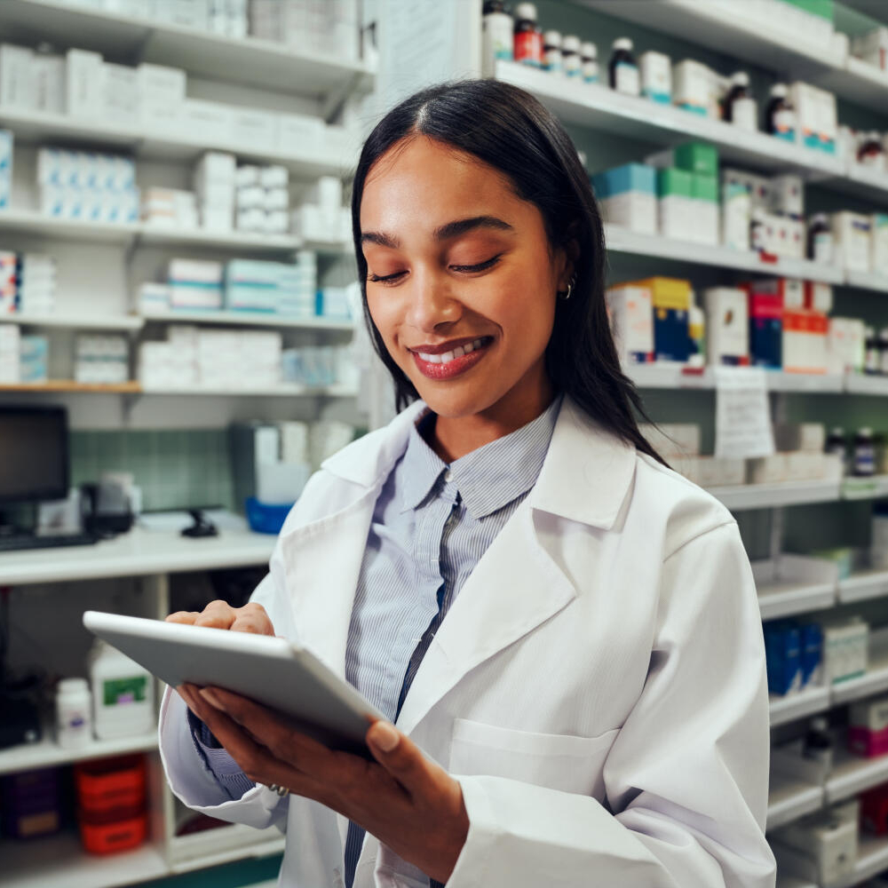 smiling pharmacist with tablet pc