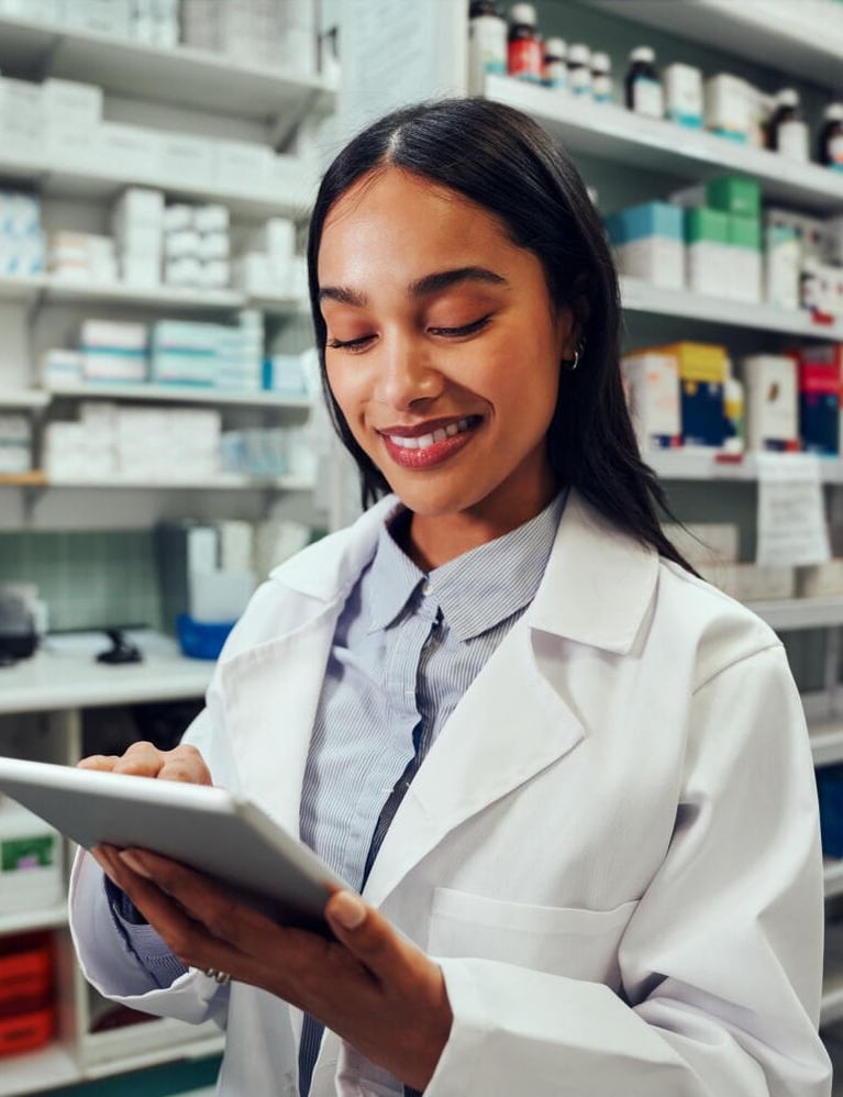 smiling pharmacist with tablet pc