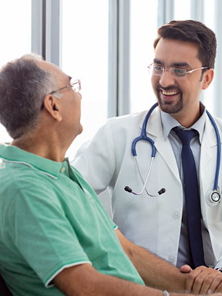 Doctor and elderly patient smiling during a consultation