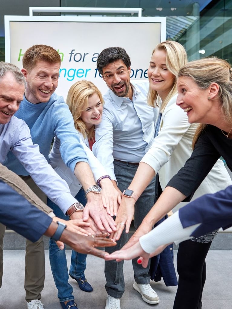 employees put their hands together 2