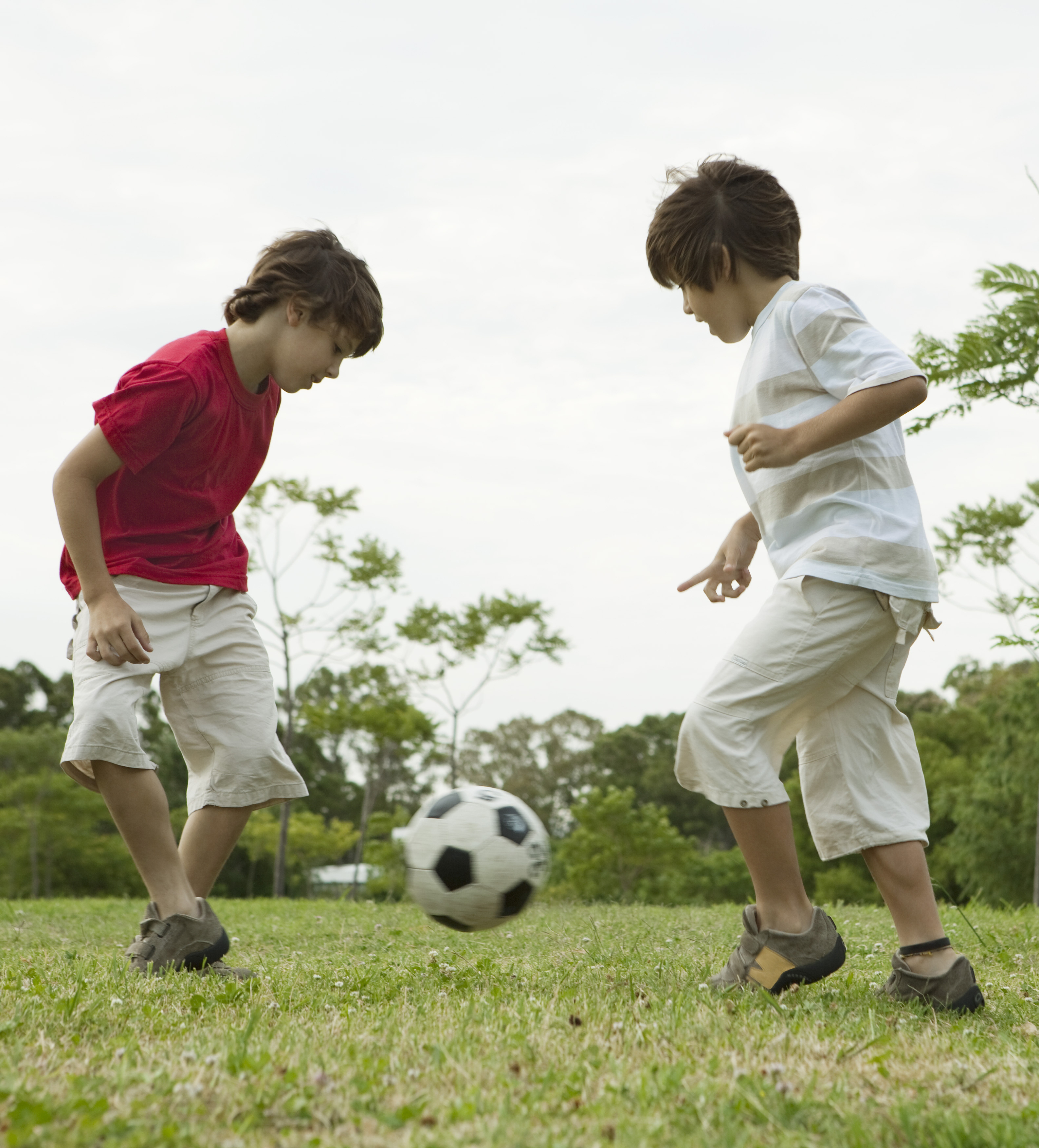 boys_playing_soccer_with_paren.jpg