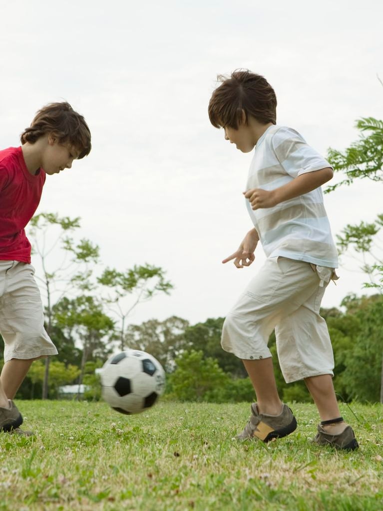 boys_playing_soccer_with_paren.jpg