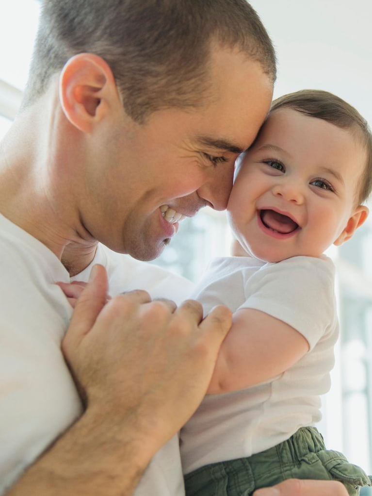 father cuddling laughing baby-square.jpg