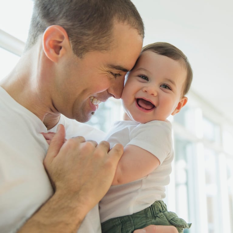 father cuddling laughing baby-square.jpg