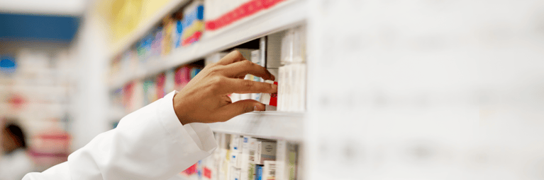 pharmacist_taking_medicine_from_rack.png