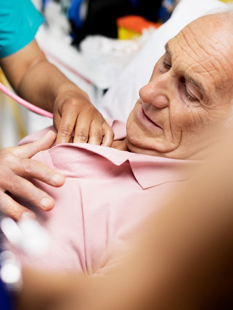 Nurse listening to patients heartbeat