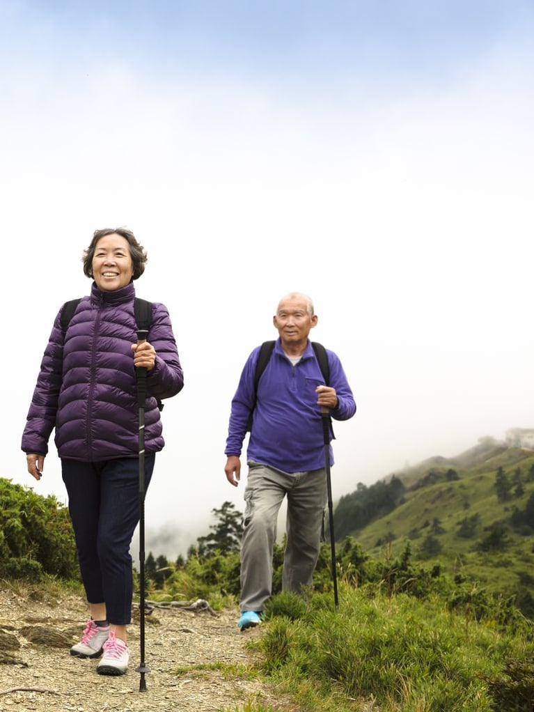 Asian senior couple hiking