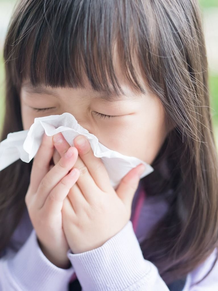 Little girl blowing her nose 1