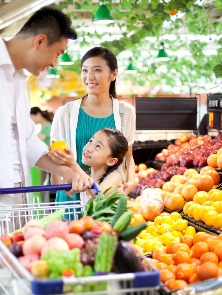 Family shopping groceries in supermarket