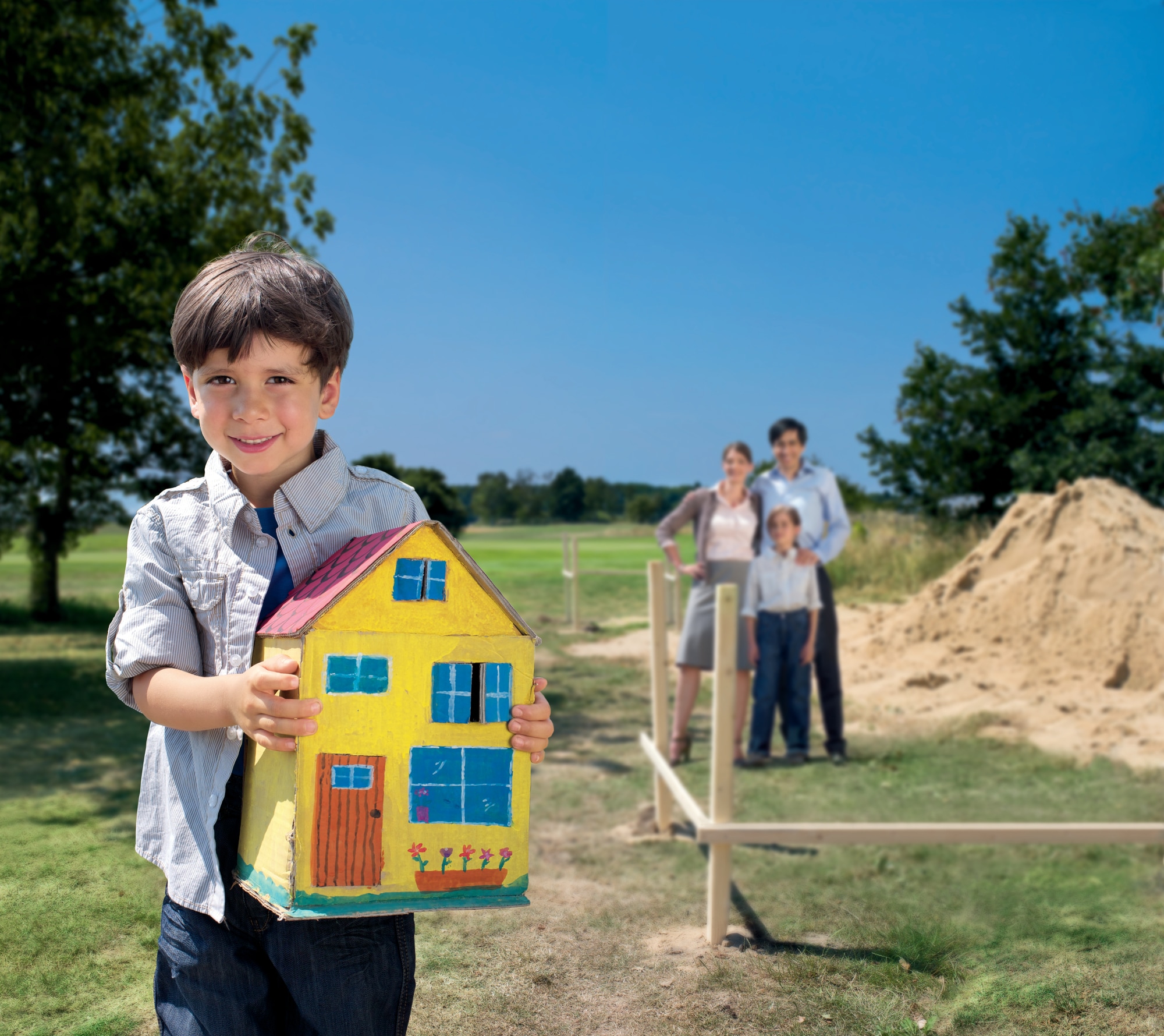 Boy holding house model