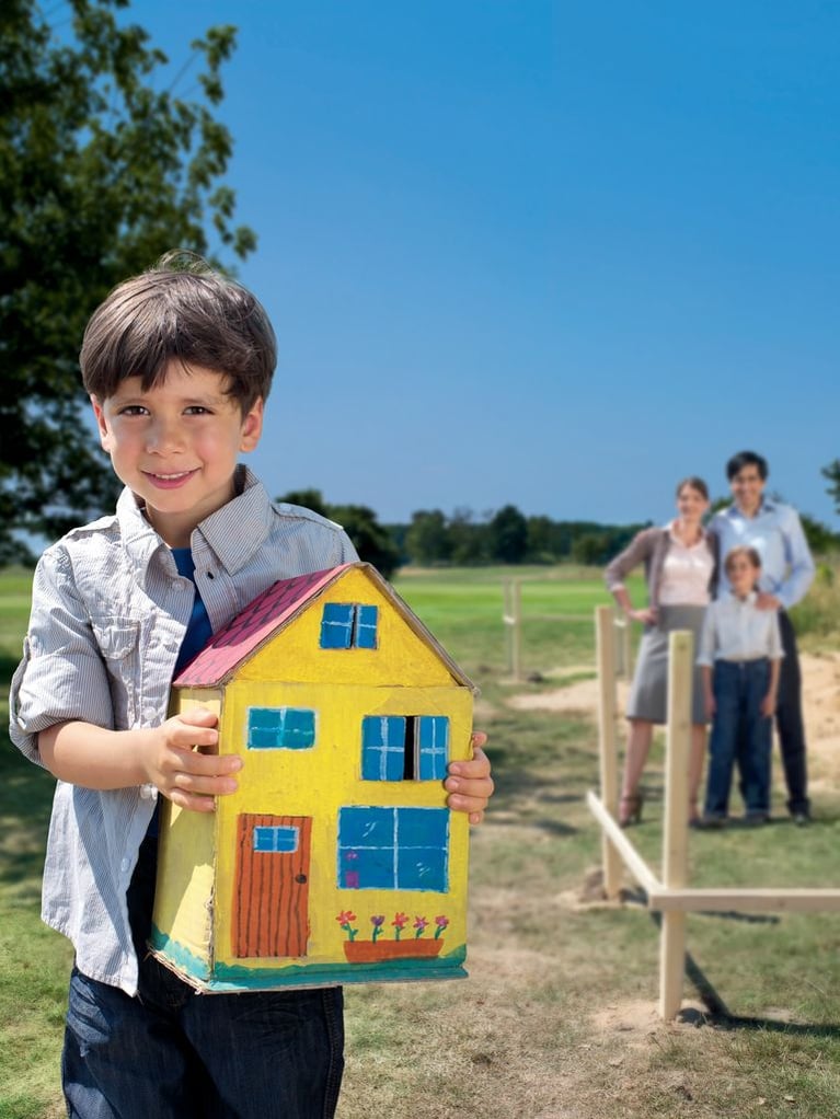 Boy holding house model