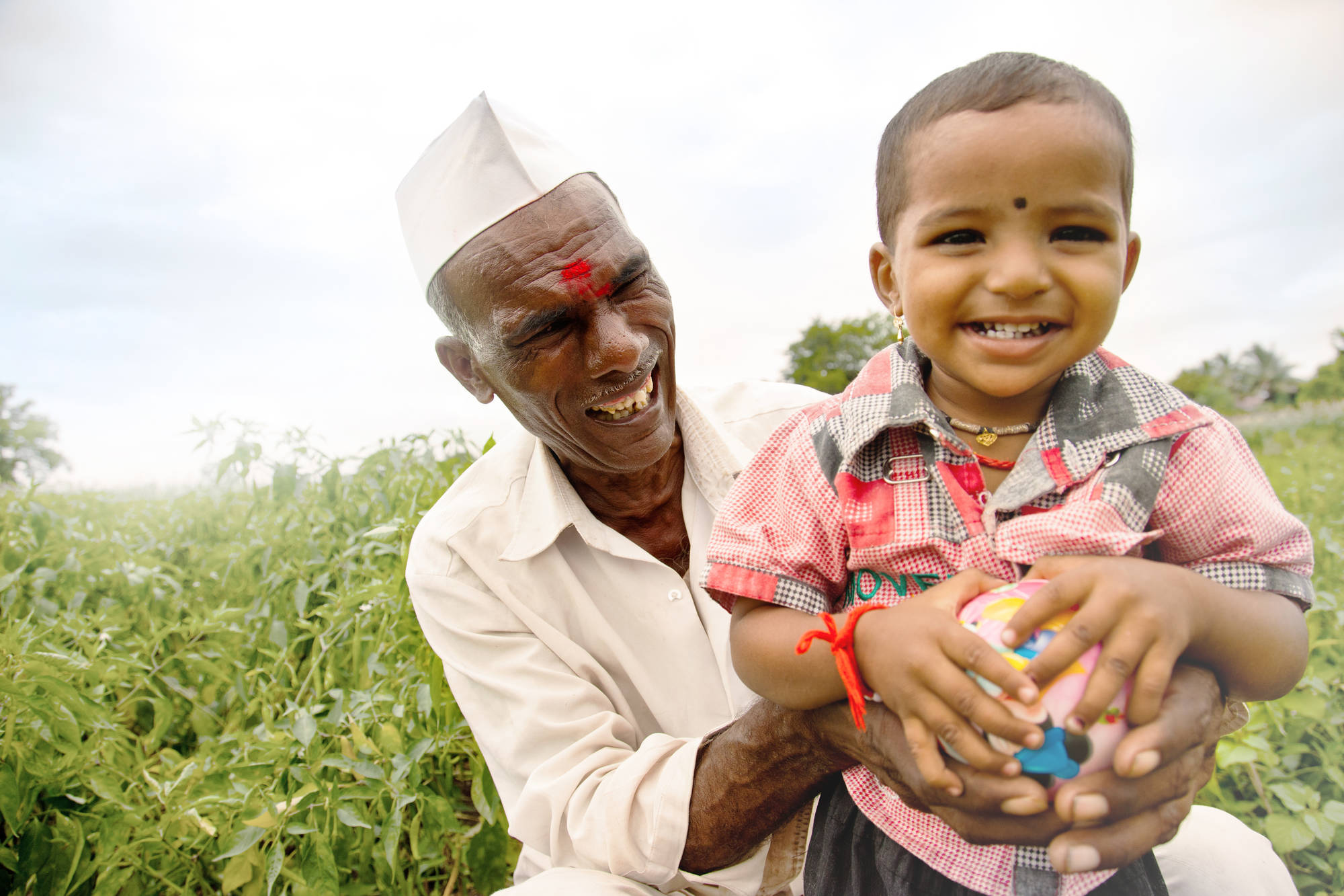 Farmer with grandson in a field