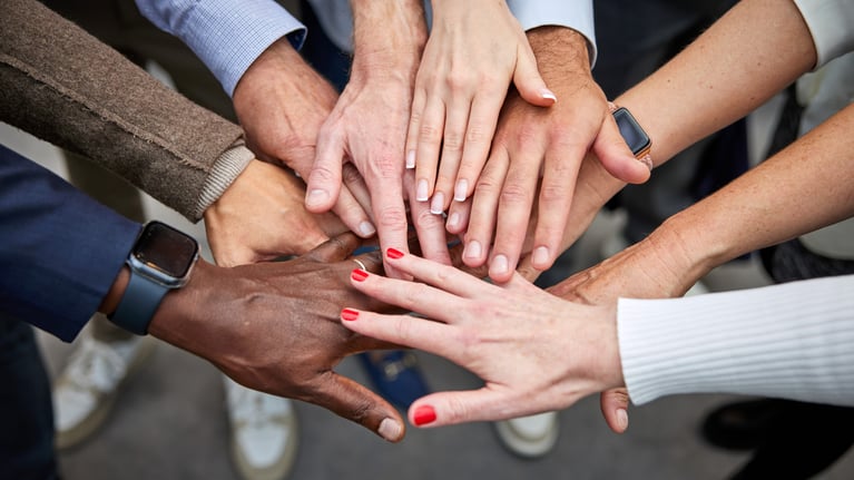 employees-put-their-hands-together-1 (1).jpg