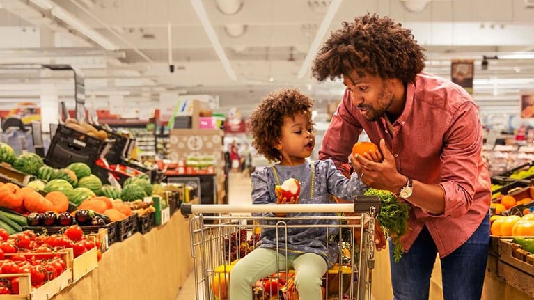 Man with girl in supermarket
