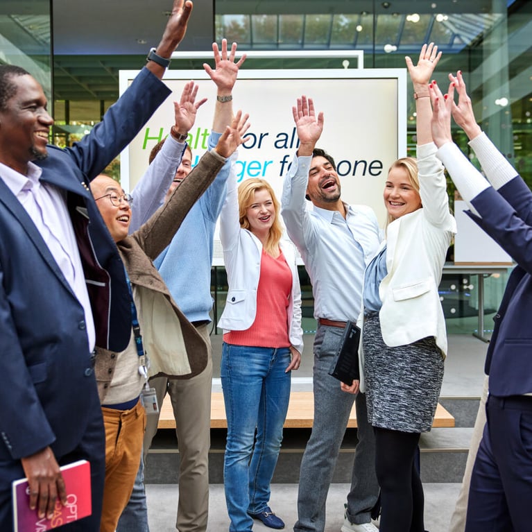 employees raise their arms 1