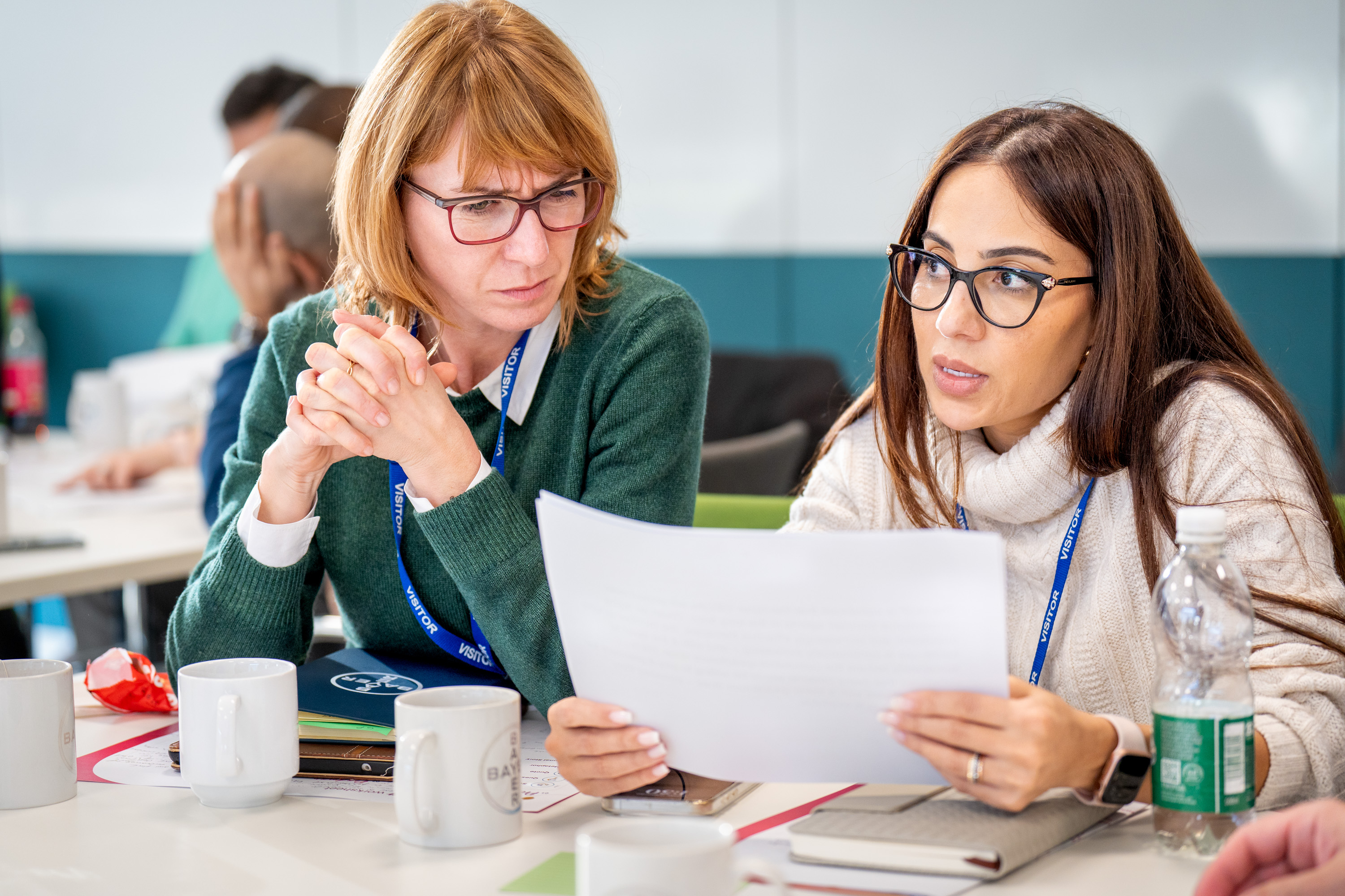 two-women-reading-paper.jpg