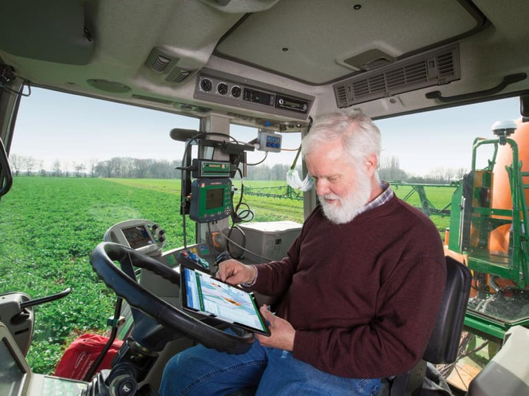 Digital_farming_expert_in_a_tractor.jpeg