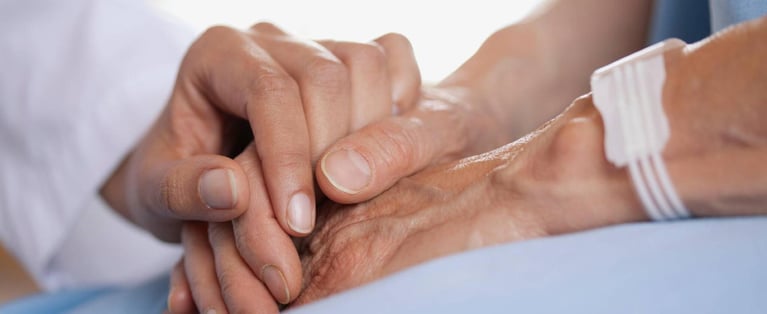Doctor_holding_patients_hand_0.jpg