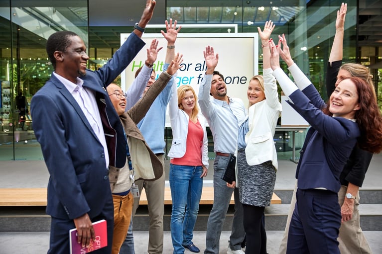employees raise their arms