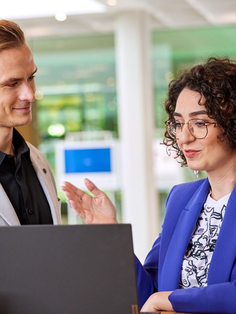bayer employees in front of a laptop