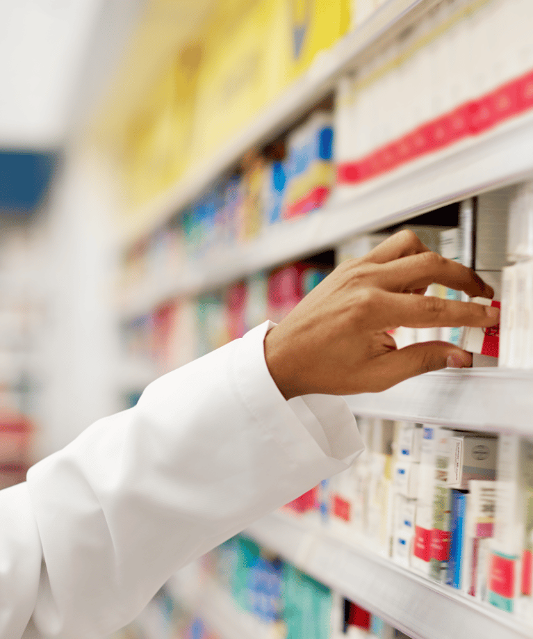 pharmacist_taking_medicine_from_rack.png