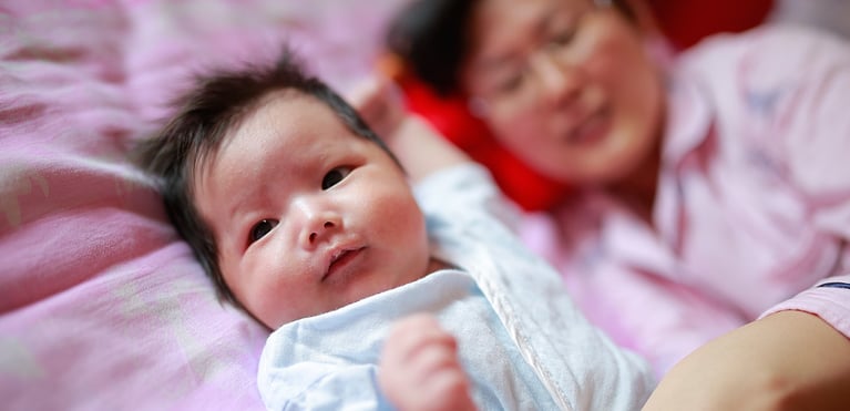 Newborn baby and mother representing the benefits of proper nutrition, vitamins and support for a healthy pregnancy..